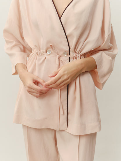 An eucalyptus-colored kimono suit with pants in an ivory color