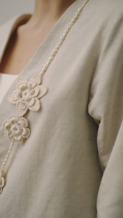 Necklace from natural pearls and knitted flowers